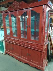 large, red-painted wooden hutch or china cabinet