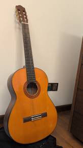 Yamaha C70 guitar with cover and book