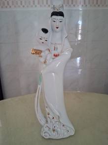 porcelain guan yin holding a children