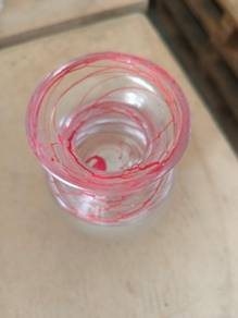 Clear glass vase with red swirl pattern
