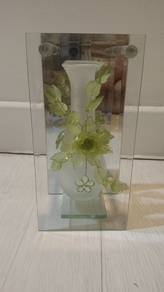 beautiful vase inside two glass mirror 