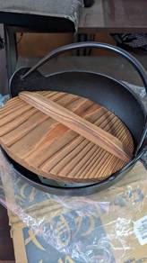 Cast iron pot with wooden lid