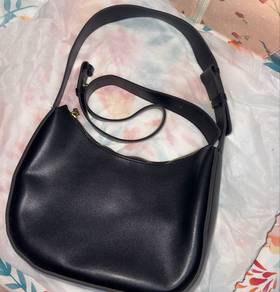Black shoulder bag with gold zipper