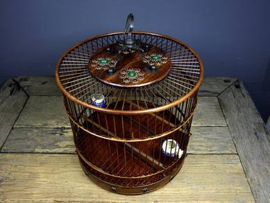 Circular rosewood birdcage inlaid with gemstones
