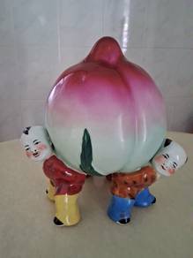 3 children holding longevity peaches