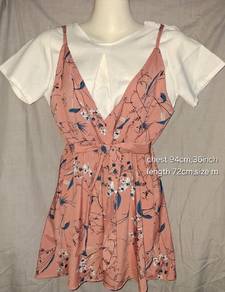 Pink florel slip dress layered over a white short 