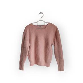 Fluffy light peach croptop knitwears.