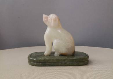 Marble dog statue on platform