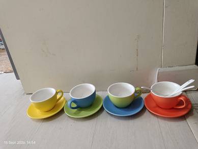 ceramic cups and saucers with spoons