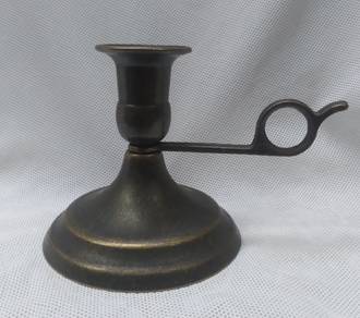 Old candlestick in brass with handle