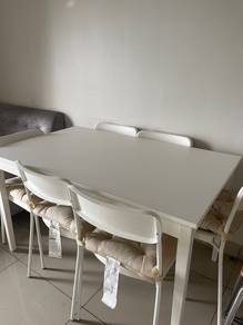 White dining table with a simple, modern design