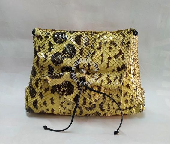 Premium Photo | Small ladies purse made of genuine snake skin on a bright  yellow surface